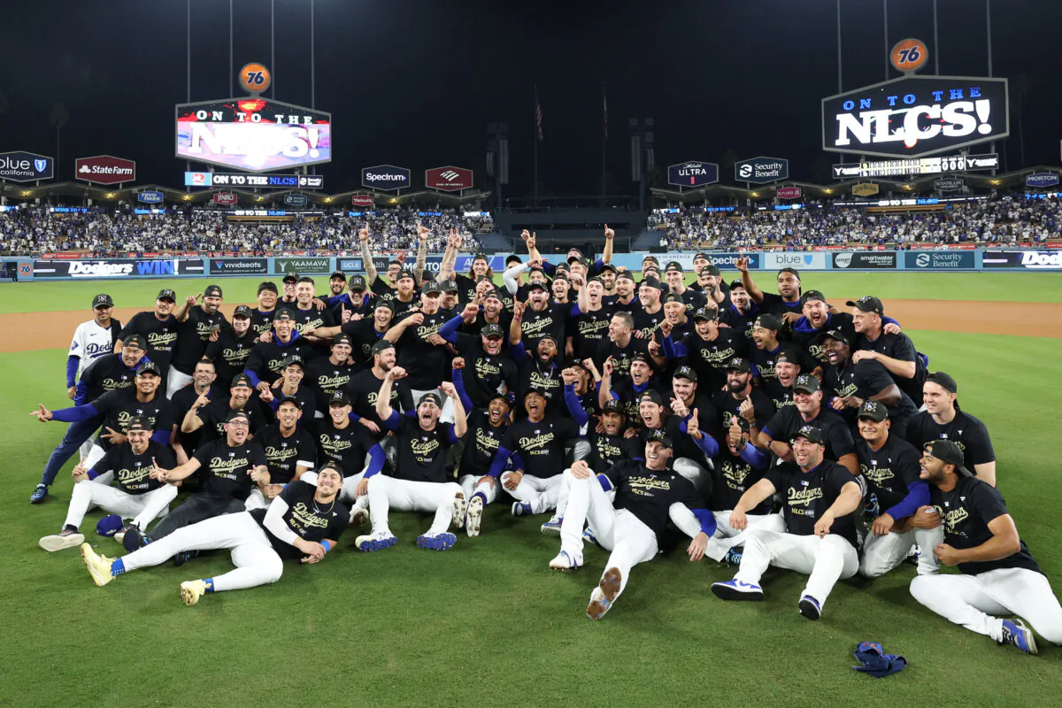 Members of the Los Angeles Dodgers pose for a photo after defeating the San Diego Padres in Game Five to win the Division Series at Dodger Stadium in Los Angeles on Oct. 11, 2024. (Harry How/Getty Images)