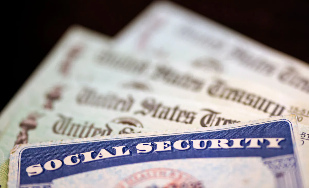 A Social Security card sits alongside checks from the U.S. Treasury in Washington on Oct. 14, 2021. (Kevin Dietsch/Getty Images)