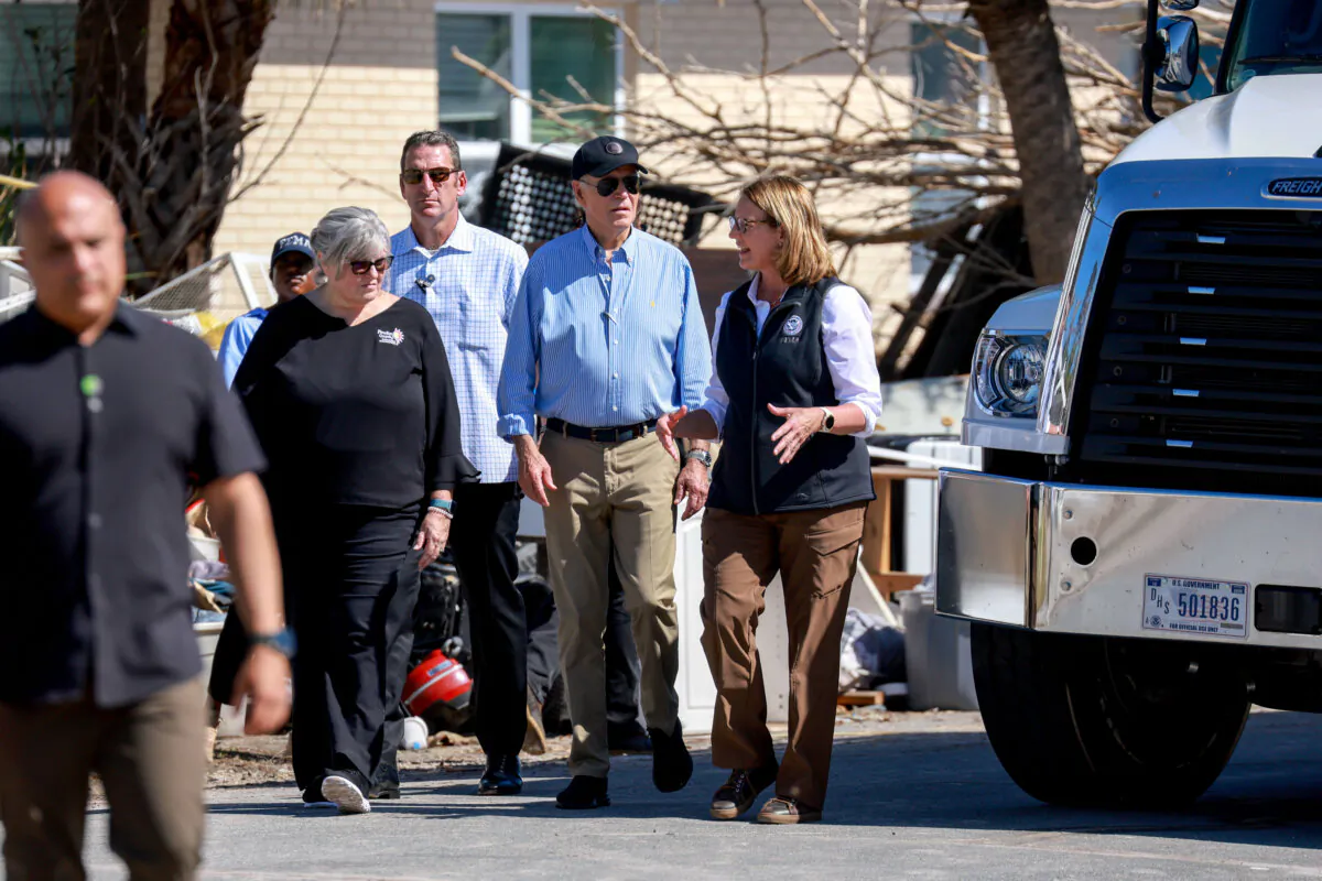 President Joe Biden walks with Pinellas County Emergency Director Cathie Perkins (L) and Deanne Criswell (R), administrator of the Federal Emergency Management Agency, during a tour of the damage caused by Hurricane Milton, in St Pete Beach, Fla., on Oct. 13, 2024. (Joe Raedle/Getty Images)