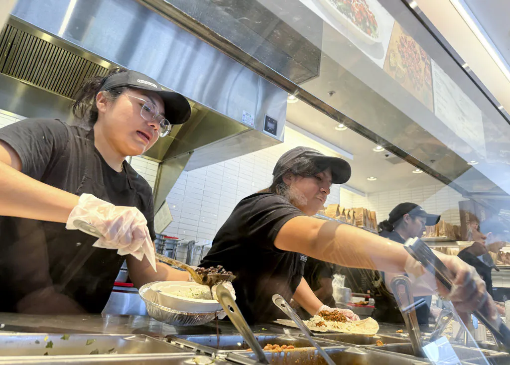 Workers fill orders at a Chipotle restaurant in San Rafael, Calif., on April 1, 2024. (Justin Sullivan/Getty Images)