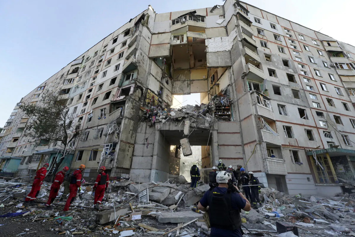 Emergency workers stand amidst the rubble after a Russian attack that hit a residential building in Kharkiv, Ukraine, on Sept. 24, 2024. (AP Photo/Andrii Marienko) 