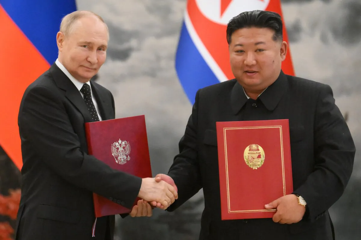 Russian President Vladimir Putin shakes hands with North Korea's leader Kim Jong Un after a signing ceremony following their bilateral talks at Kumsusan state residence in Pyongyang, on June 19, 2024. (Kristina Kormilitsyna/AFP via Getty Images)