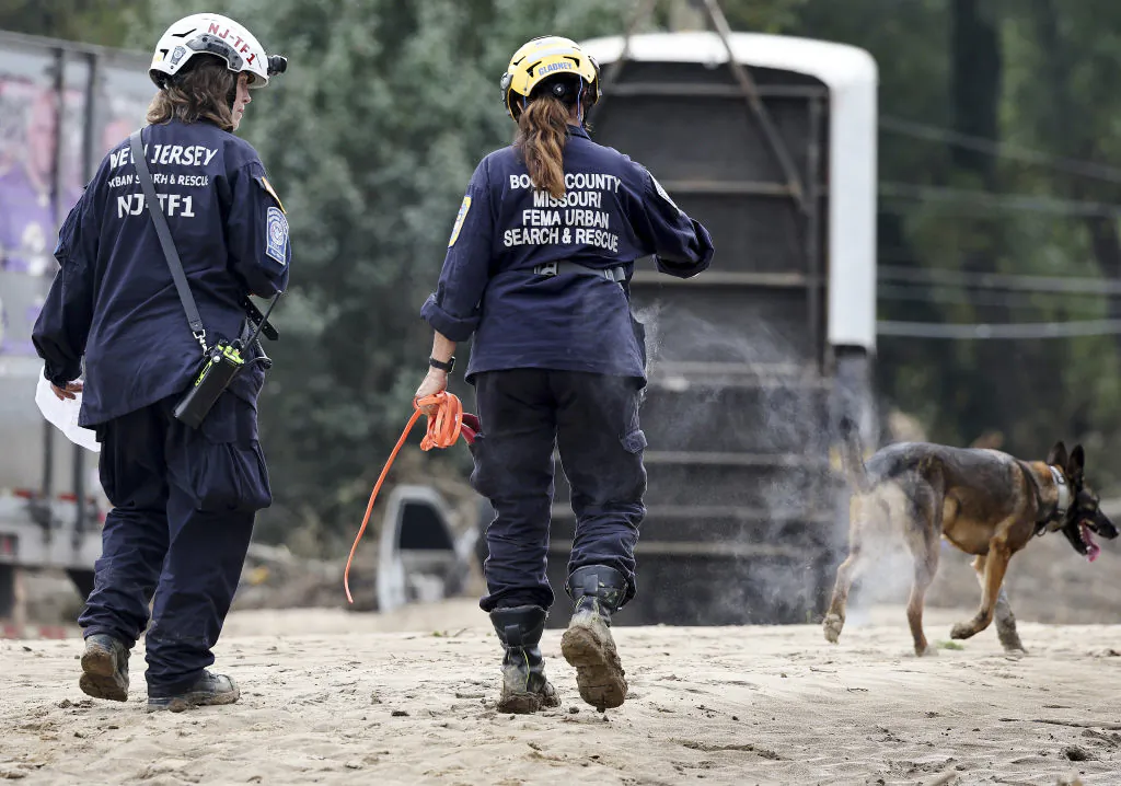 Members of the FEMA Urban Search and Rescue Task Force search a flood-damaged area with a search canine in the aftermath of Hurricane Helene along the Swannanoa River in Asheville, N.C., on Oct. 4, 2024. (Mario Tama/Getty Images)