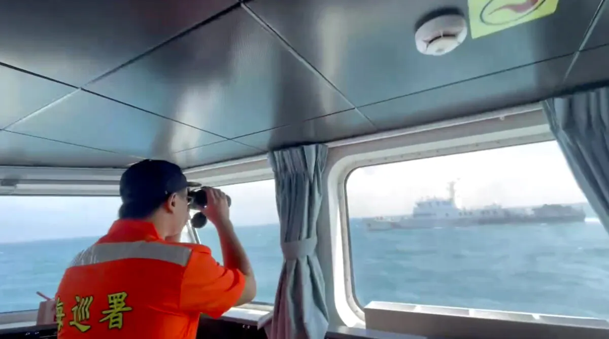 In this file image, a member of the Taiwan Coast Guard monitors a China Coast Guard boat as it passes near the coast of Matsu islands, Taiwan, on Oct. 14, 2024, in a still from video. (Taiwan Coast Guard via AP)