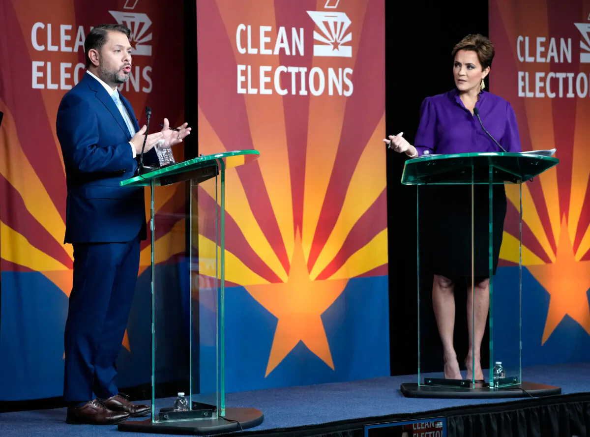 U.S. Senate candidates Rep. Ruben Gallego (D-Ariz.) (L) and Republican challenger Kari Lake participate in a debate in Phoenix on Oct. 9, 2024. (Cheryl Evans/Arizona Republic via AP)