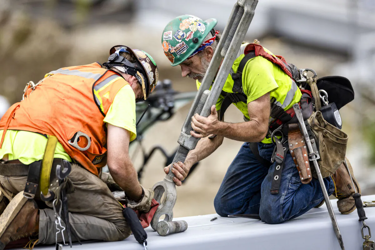 Workers prepare to lift a new pedestrian bridge into place in Stamford, Conn., on Aug. 26, 2023. (John Moore/Getty Images)