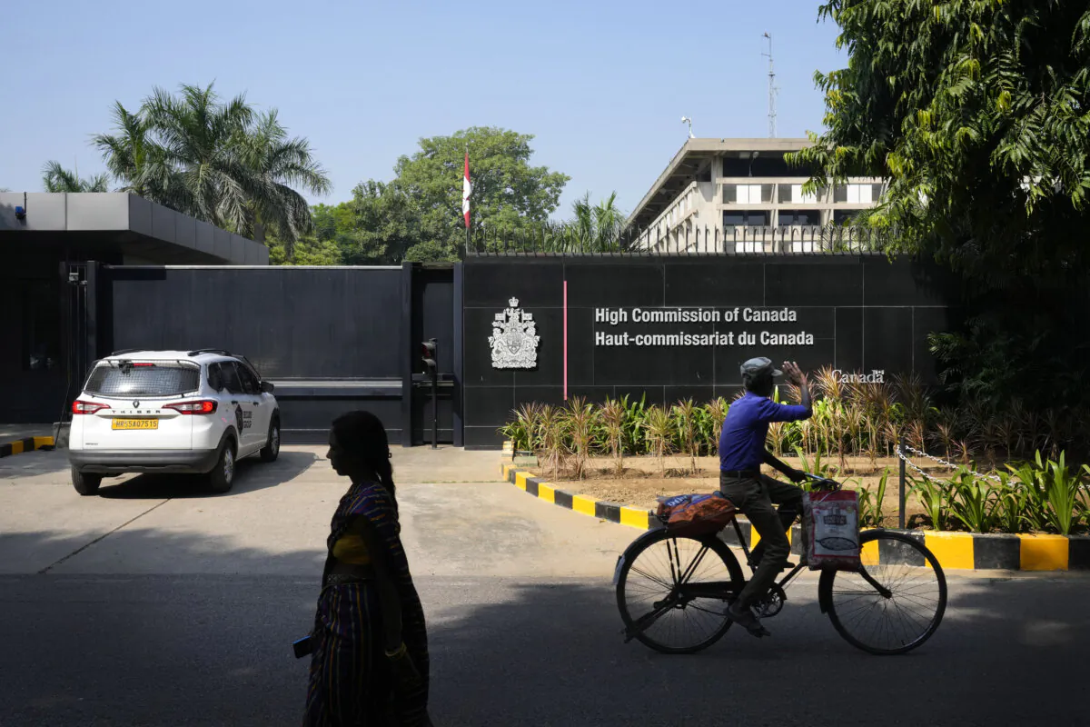A cyclist pedals past the Canadian high commission in New Delhi, India, on Oct. 15, 2024. (The Canadian Press/AP-Manish Swarup)