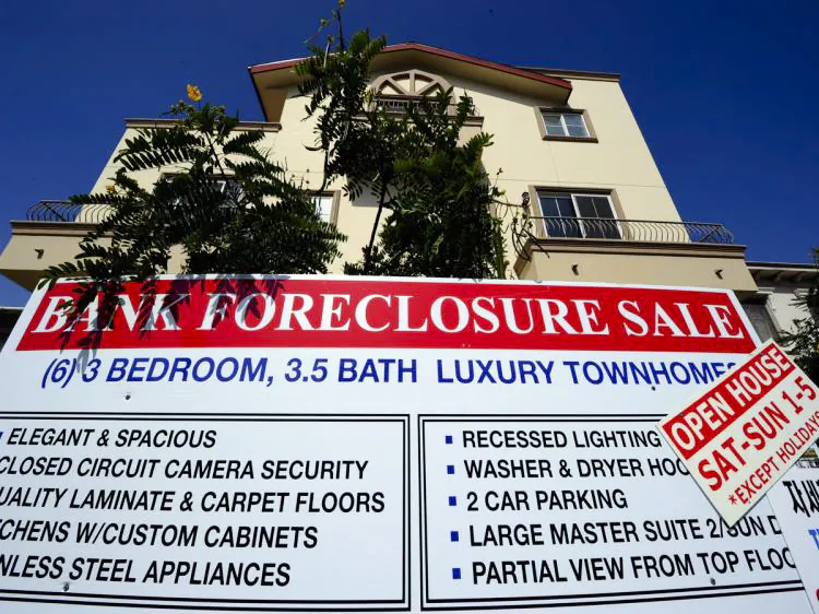 A 'Bank Foreclosure Sale' sign is posted in front of townhomes in Los Angeles, Calif. (Kevork Djansezian/Getty Images)