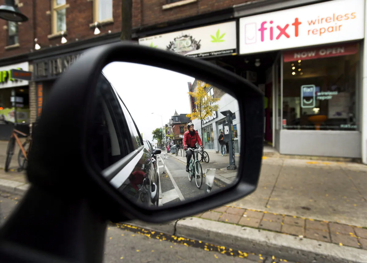 Cyclists ride in a bike lane in Toronto on Oct. 12, 2017. (The Canadian Press/Nathan Denette)