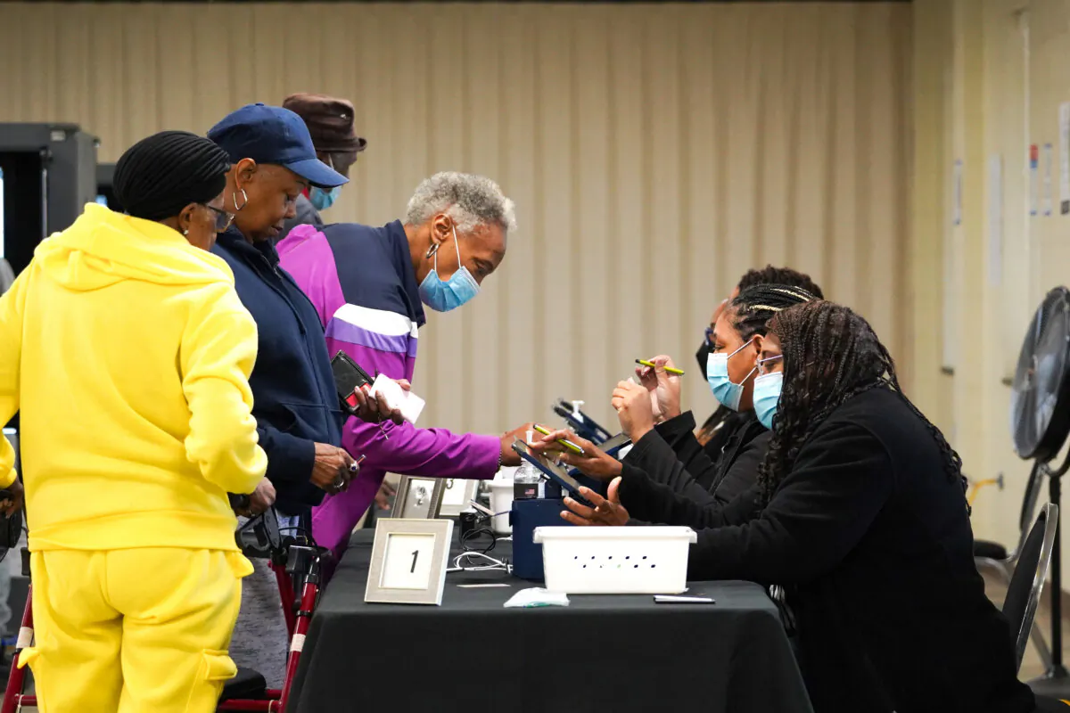 People sign in to cast their votes on the first day of early voting at East Point First Mallalieu United Methodist Church in Atlanta on Oct. 15, 2024. (Megan Varner/Getty Images)
