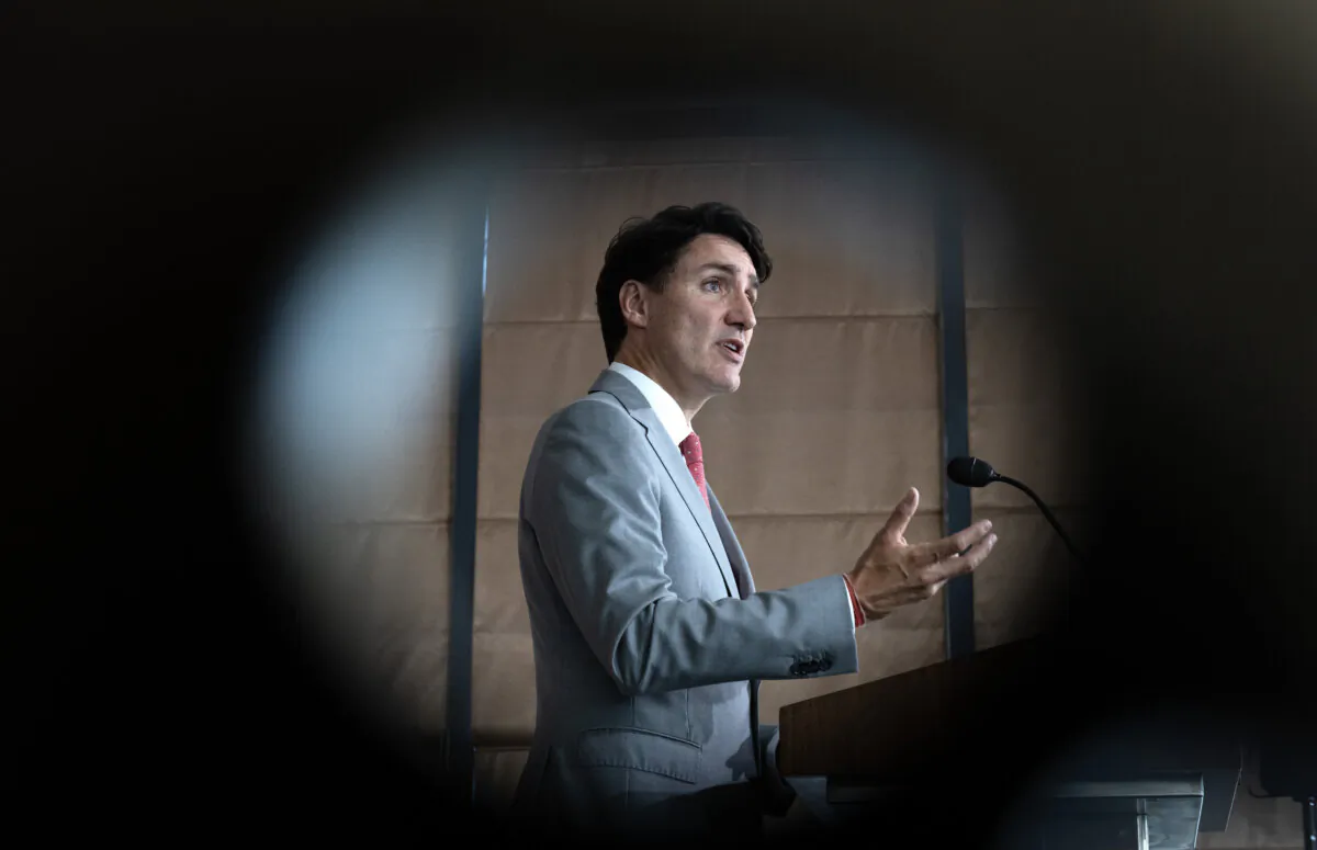 Prime Minister Justin Trudeau gestures during a news conference in Vientiane, Laos, on Oct. 11, 2024. (The Canadian Press/Adrian Wyld)