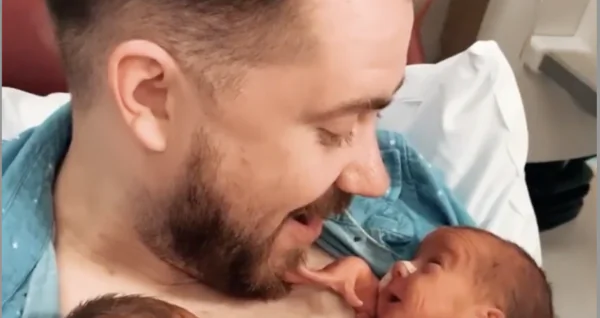 Newborn Baby Opens a Huge Smile to Greet Daddy