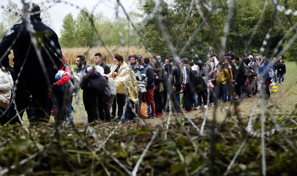 In this undated file photo, people cross a border from Croatia near the village of Zakany, Hungary. (Petr David Josek/AP Photo)