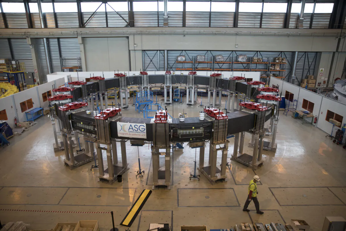 A worker walks by the ITER poloidal field coil #5 designed to shape plasma and meant for the assembly of the ITER tokamak in Saint-Paul-Lez-Durance, France, on July 28, 2020. (AP Photo/Daniel Cole)