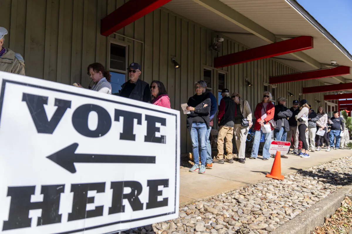 People stand in line at a polling place on the first day of early in-person voting in Black Mountain, N.C., on Oct. 17, 2024. (AP Photo/Stephanie Scarbrough)