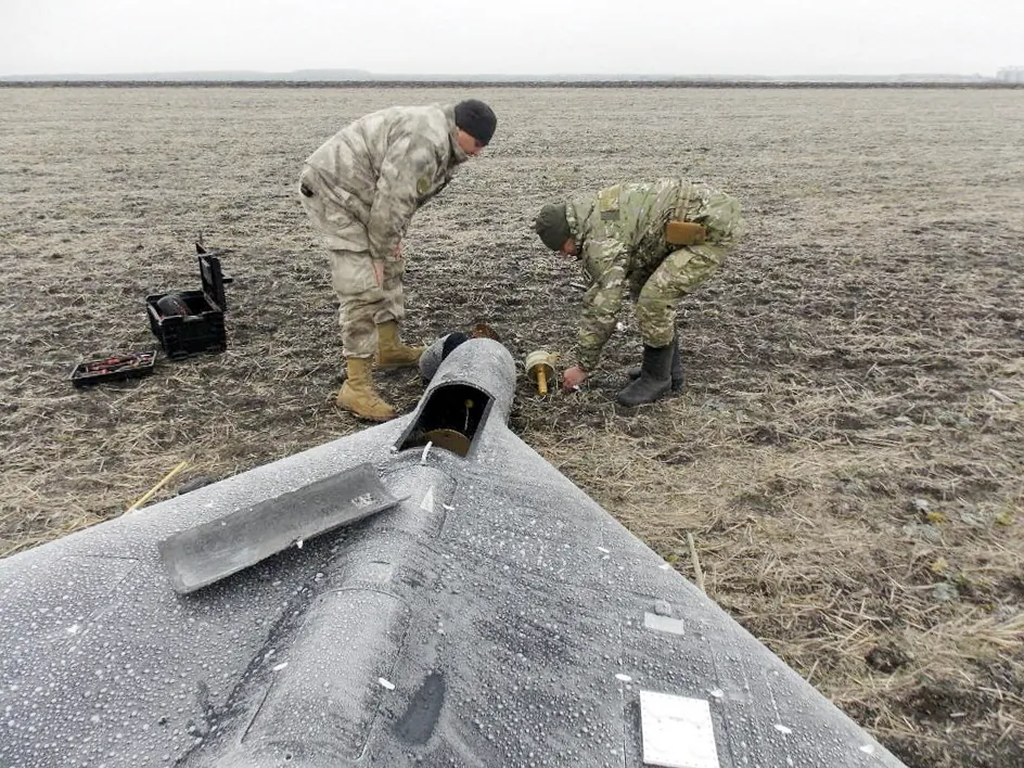 A police demining unit in an unknown location in Ukraine removes a warhead from a Russian kamikaze unmanned aerial vehicle that landed by radio electronic warfare during drone strikes, amid Russia's attacks, in this photo in Ukraine released on Jan. 26, 2024. (Press service of the National Police of Ukraine/Handout via Reuters)