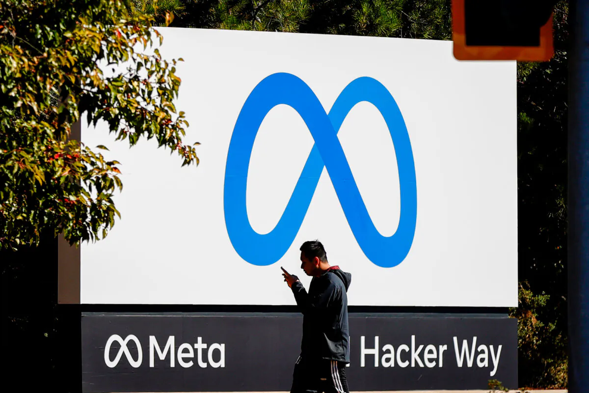 A pedestrian walks in front of the Meta logo at the Facebook headquarters in Menlo Park, Calif., on Oct. 28, 2021. (Justin Sullivan/Getty Images)