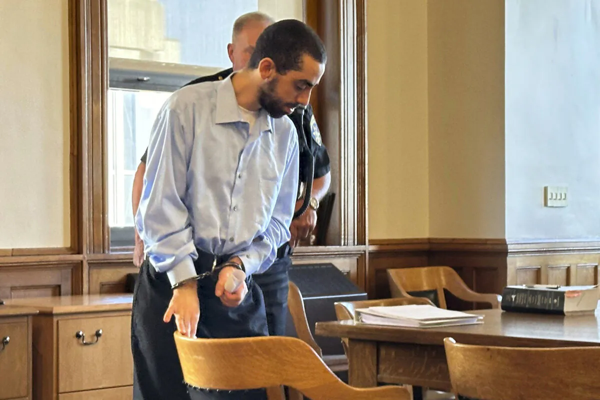 Hadi Matar, charged with attempted murder for stabbing author Salman Rushdie more than a dozen times, is escorted into the courtroom for a hearing in Chautauqua County Court in Mayville, N.Y., on Oct. 4, 2024. (Carolyn Thompson/AP Photo)