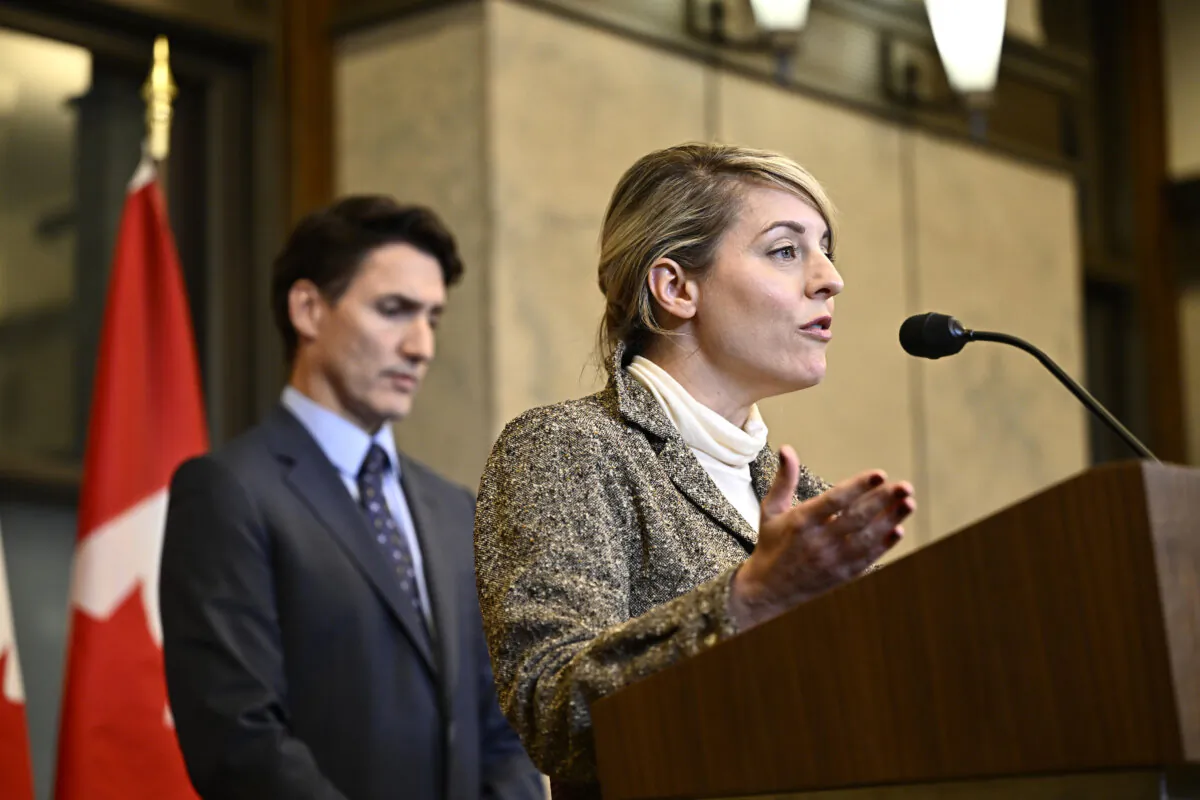 Minister of Foreign Affairs Melanie Joly speaks as Prime Minister Justin Trudeau listens during a news conference on the investigative efforts related to violent criminal activity occurring in Canada with connections to India in Ottawa on Oct. 14, 2024. (The Canadian Press/Justin Tang)