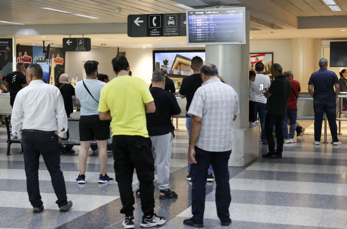 People stand at Beirut-Rafic Hariri International Airport, a day after hand-held radios used by terrorist group Hezbollah detonated across Lebanon's south, in Beirut, Lebanon, on Sept. 19, 2024. (Mohamed Azakir/Reuters)