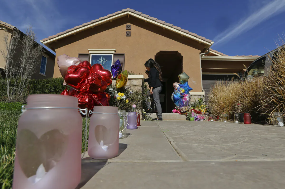 FILE - Neighbors write down messages for the Turpin's children on the front door of the home of David and Louise Turpin where police arrested the couple accused of holding 13 children captive in Perris, Calif., Jan. 24, 2018. (Damian Dovarganes/AP Photo)