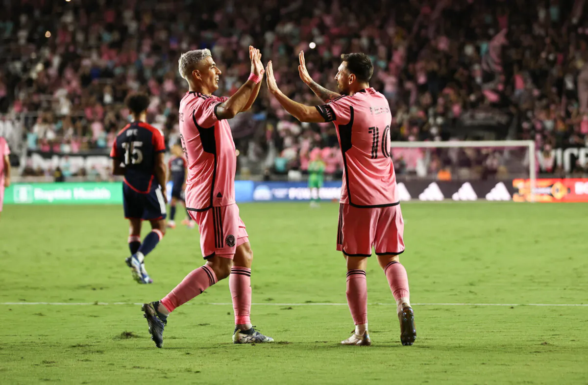 Inter Miami's Argentine forward #10 Lionel Messi celebrates with Uruguayan forward #09 Luis Suarez after scoring his team's fifth goal during the Major League Soccer (MLS) football match between Inter Miami and New England Revolution at Chase Stadium in Fort Lauderdale, Fla., on Oct. 19, 2024. (Chris Arjoon/AFP via Getty Images)