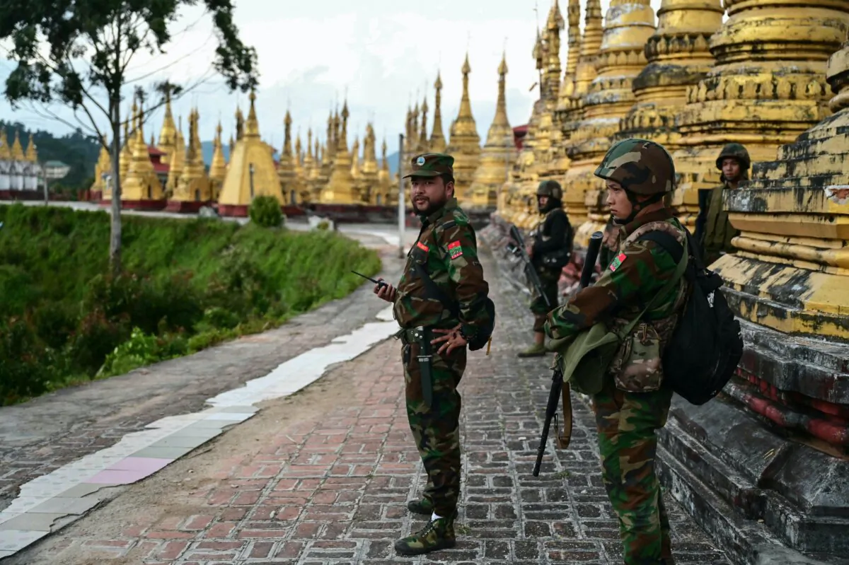 Members of the ethnic minority armed group Ta'ang National Liberation Army (TNLA) standing guard in a temple area of a hill camp seized from Burma's military in Namhsan Township, in Burma's northern Shan State, on Dec. 13, 2023. (STR/AFP via Getty Images)