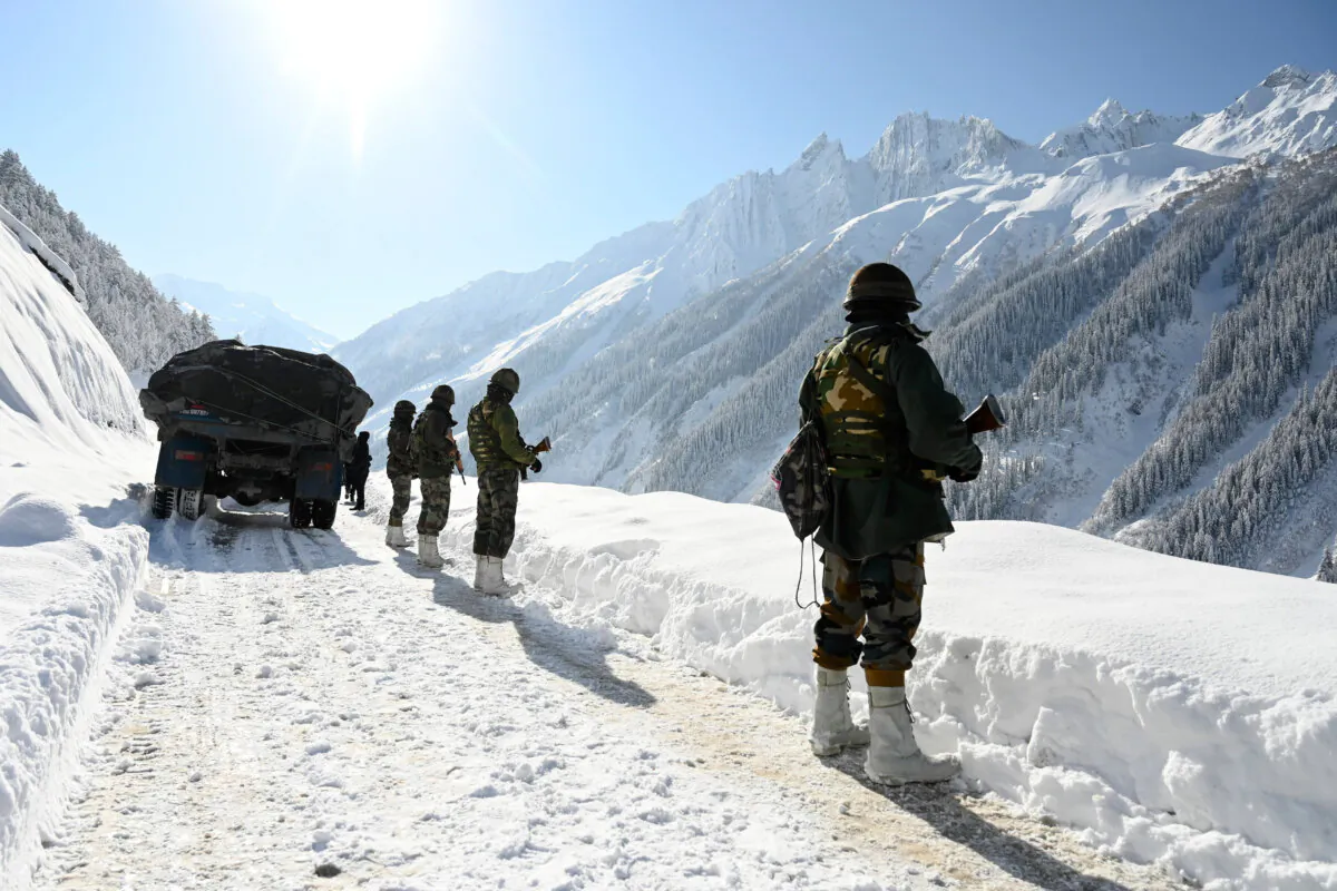 Indian army soldiers walk along a road near Zojila mountain pass that connects Srinagar to the union territory of Ladakh, bordering China, on Feb. 28, 2021. (Tauseef Mustafa/AFP via Getty Images)