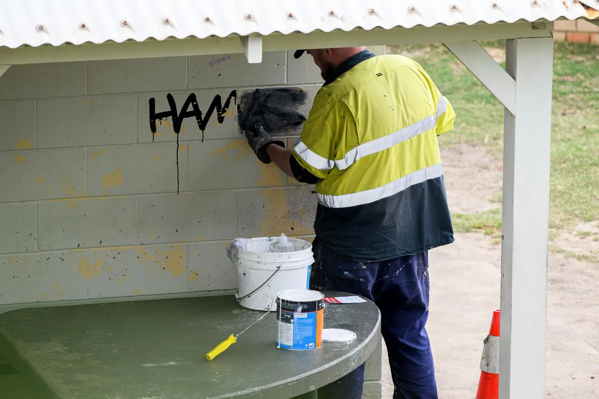 A council worker is seen removing Hamas-related graffiti at Bronte Beach in Sydney, Australia, on Oct. 21, 2024. (AAP Image/Bianca De Marchi)
