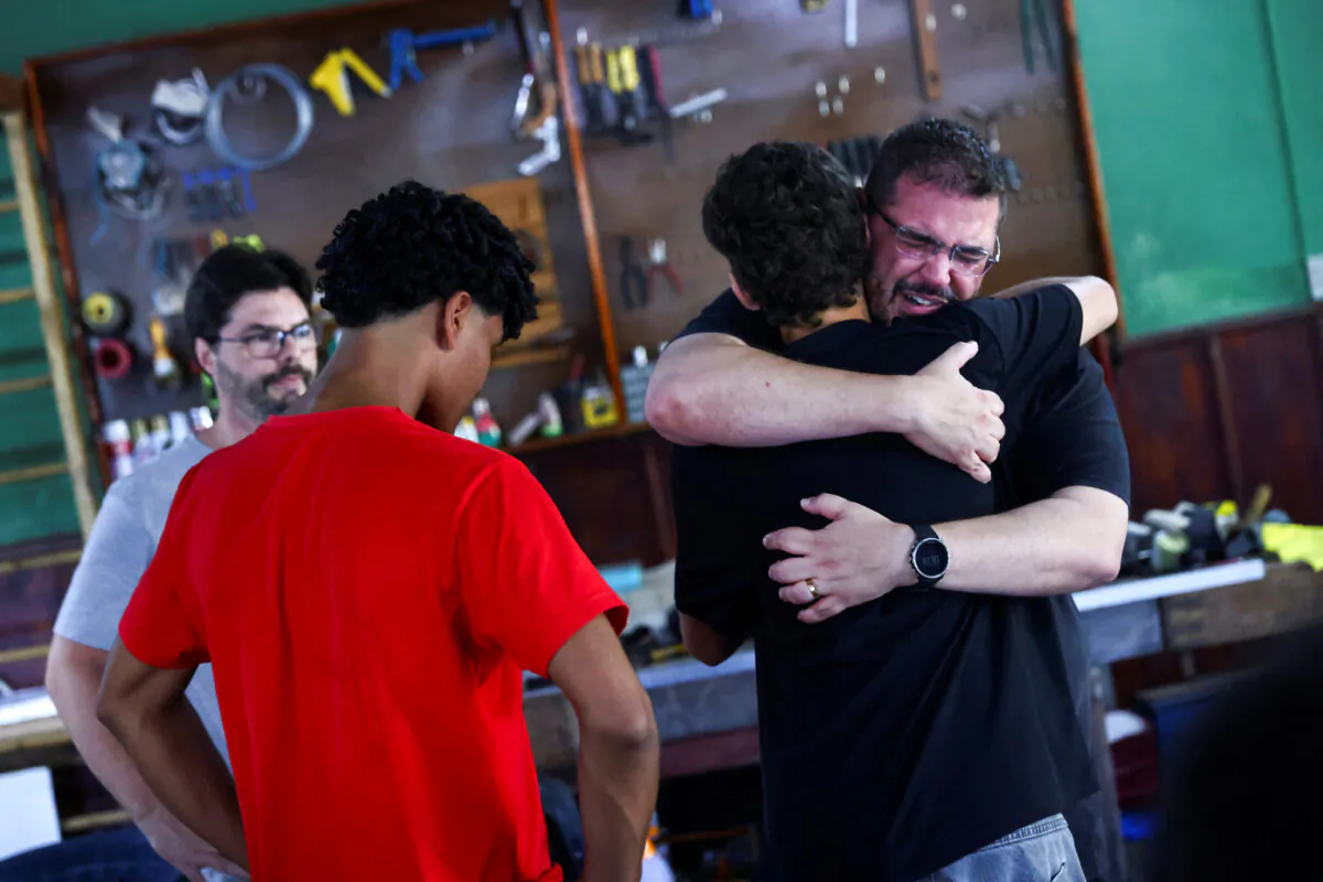 Relatives of victims of the accident that killed nine members of the rowing team of the social project Remar Para o Futuro hug each other at the club's headquarters, in the city of Pelotas, in the state of Rio Grande do Sul, Brazil, on Oct. 21, 2024. (Diego Vara/Reuters)