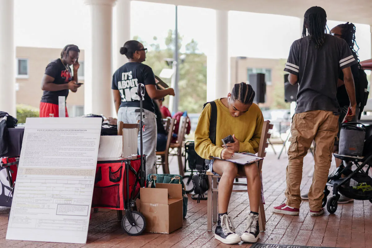 A student fills out a voter registration form at Morehouse College in Atlanta on Aug. 19, 2024. (Elijah Nouvelage/ AFP via Getty Images)