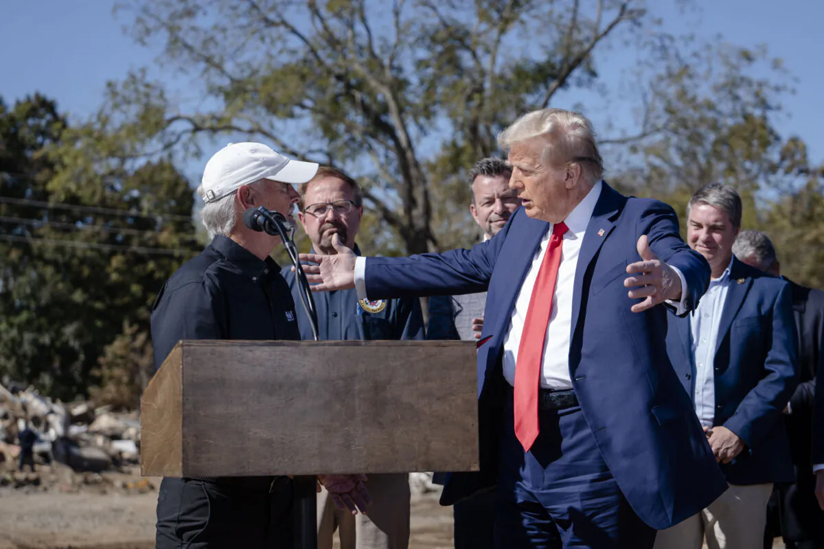 Mike Stewart prays for Republican presidential candidate, former President Donald J. Trump in Asheville, N.C., on Oct. 21, 2024. (Madalina Vasiliu/The Epoch Times)