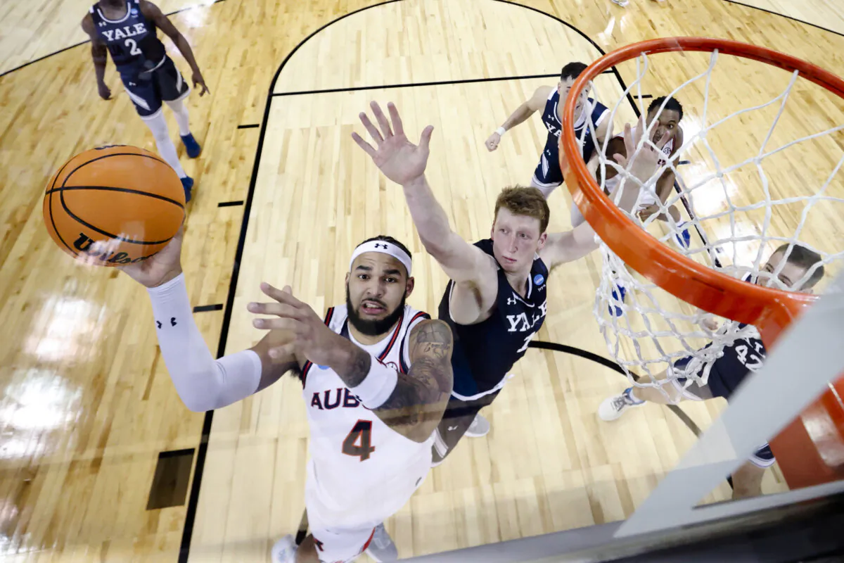 Johni Broome #4 of the Auburn Tigers drives to the basket against Danny Wolf #1 of the Yale Bulldogs during the second half in the first round of the NCAA Men's Basketball Tournament at Spokane Veterans Memorial Arena in Spokane, Wash., on March 22, 2024. (Steph Chambers/Getty Images)
