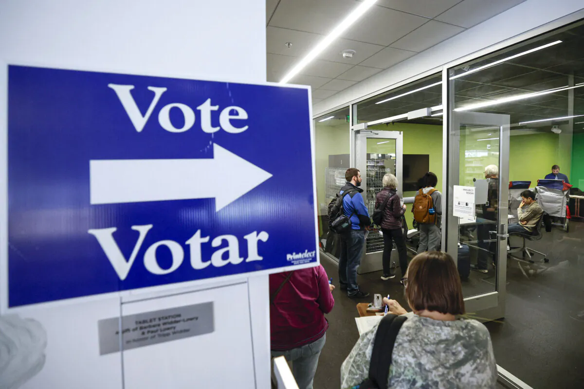Voters wait in line to cast their votes at an early-voting polling location at the Madison Public Library–Central in Madison, Wis., on Oct. 22, 2024. (Kamil Krzaczynski/AFP via Getty Images)