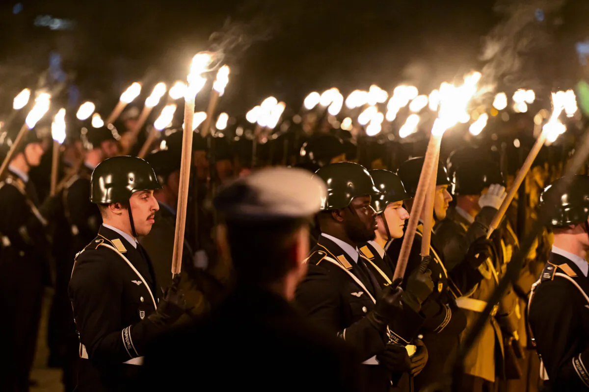 Members of a military honor guard hold torches during a military sending-off ceremony (Zapfenstreich) in honour of former NATO Secretary General Jens Stoltenberg at the Defence Ministry in Berlin, on Oct. 22, 2024. (John Macdougall/AFP via Getty Images)