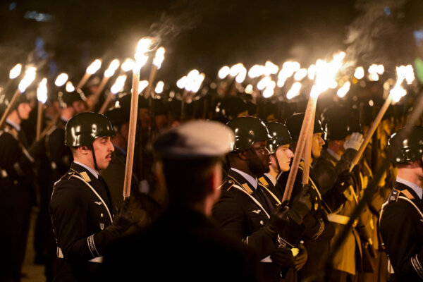 Day in Photos: A Military Send-Off; a Dispersing Flock of Pigeons; and a Building Collapse