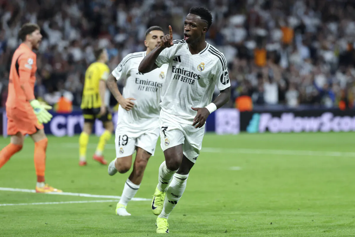 Real Madrid's Brazilian forward #07 Vinicius Junior celebrates scoring a hat-trick and his team's fifth goal during the UEFA Champions League, league phase day 3 football match between Real Madrid CF and Borussia Dortmund at the Santiago Bernabeu stadium in Madrid on Oct. 22, 2024. (Thomas Coex/AFP via Getty Images)