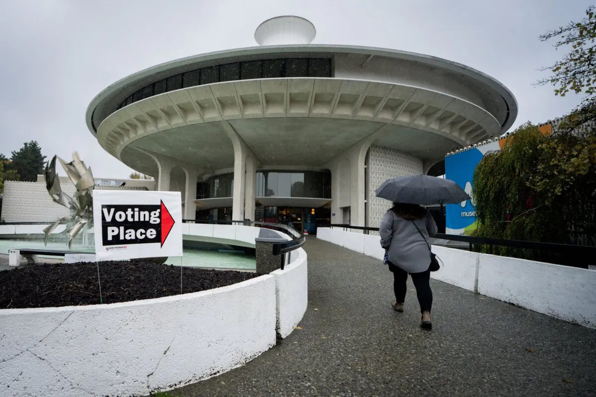A woman walks to a polling station in Vancouver to vote on election day, on Oct. 19, 2024. (The Canadian Press/Ethan Cairns)