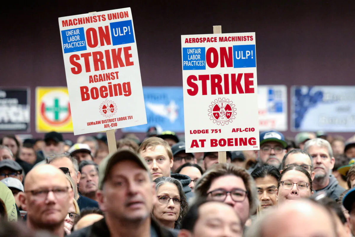 People hold signs during a strike rally for the International Association of Machinists and Aerospace Workers (IAM) at the Seattle Union Hall in Seattle on Oct. 15, 2024. (Jason Redmond/AFP via Getty Images)