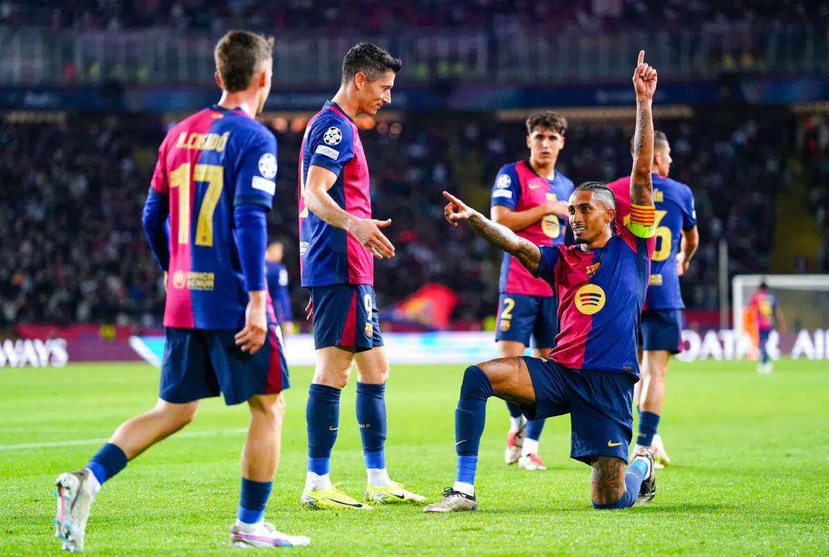Raphinha of FC Barcelona celebrates scoring his team's fourth goal and his hat-trick goal with teammates during the UEFA Champions League 2024/25 League Phase MD3 match between FC Barcelona and FC Bayern Munchen at Estadi Olimpic Lluis Companys in Barcelona, Spain, on October 23, 2024. (Pedro Salado/Getty Images)
