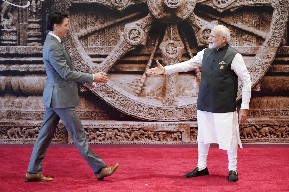 India’s Prime Minister Narendra Modi and Prime Minister Justin Trudeau approach each other to shake hands ahead of the G20 Leaders’ Summit in New Delhi on Sept. 9, 2023. (Evan Vucci/POOL/AFP via Getty Images)