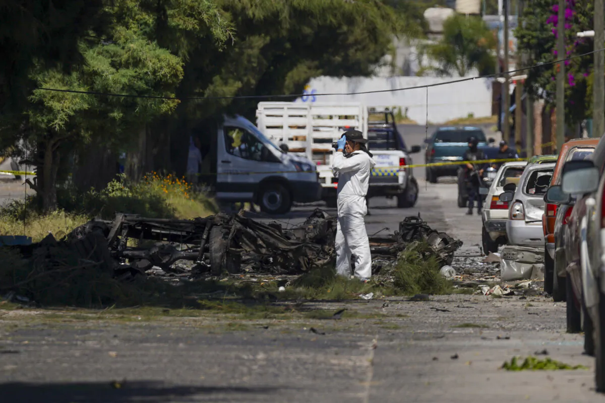 A forensic investigator works the scene where a car bomb exploded near a police station, in Acambaro, Guanajuato state, Mexico, on Oct. 24, 2024. (Armando Solis/AP Photo)