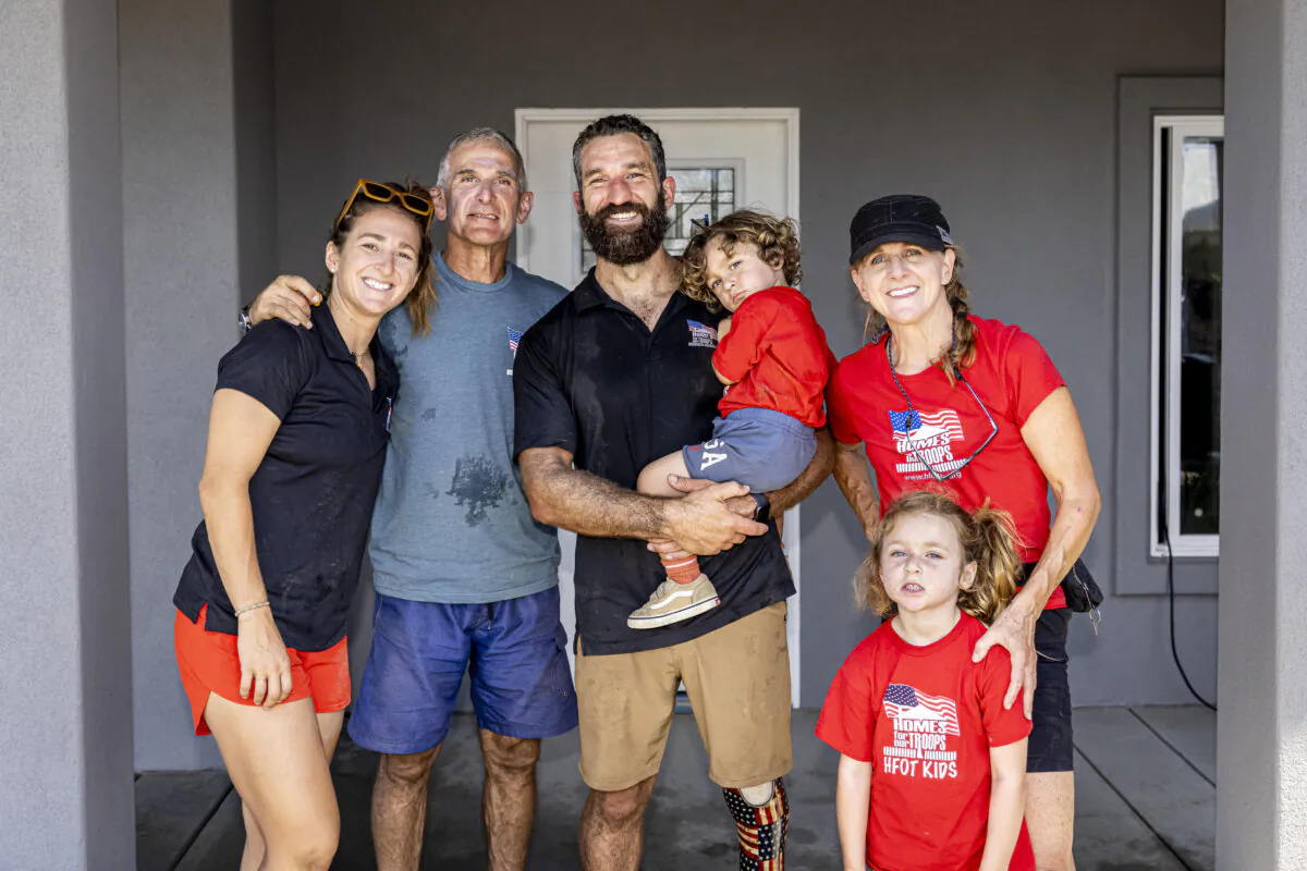 Redmond Ramos with his family in front of his new home provided by Homes for Our Troops. (Ron Cole Photography)