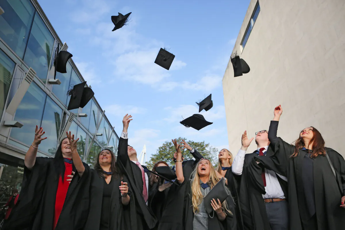 Students throw their caps in the air ahead of their graduation ceremony at the Royal Festival Hall in London on Oct. 13, 2015. (Dan Kitwood/Getty Images)