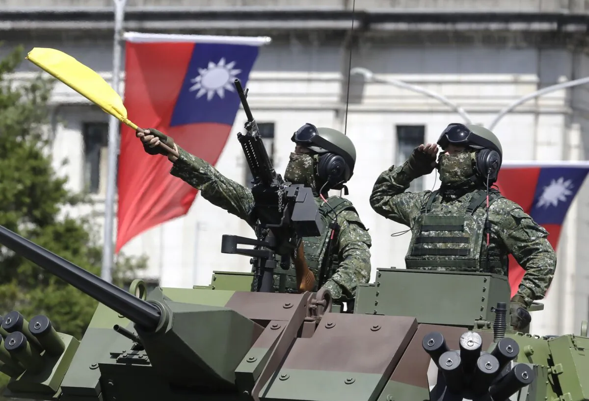 Taiwanese soldiers salute during National Day celebrations in front of the Presidential Building in Taipei, Taiwan, on Oct. 10, 2021. (Chiang Ying-ying/AP Photo)