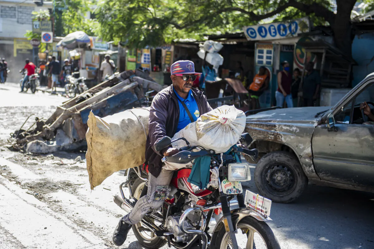 A man flees his neighborhood after armed gangs terrorized the Delmas 24 and Solino areas in Port-au-Prince, Haiti, on Oct. 26, 2024. (Clarens Siffroy/AFP via Getty Images)