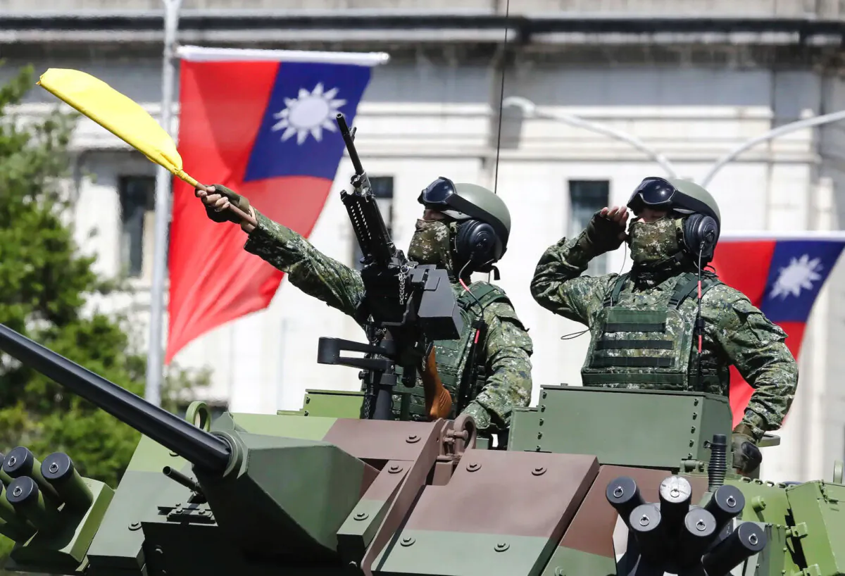 Taiwanese soldiers salute during National Day celebrations in front of the Presidential Building in Taipei, Taiwan, on Oct. 10, 2021. (Chiang Ying-ying/AP Photo)