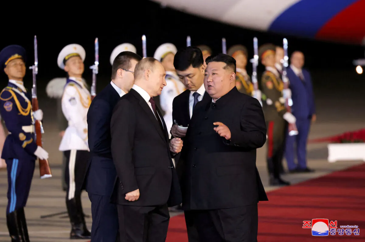 Russian President Vladimir Putin is welcomed by North Korean leader Kim Jong Un upon his arrival at an airport in Pyongyang, North Korea, on June 19, 2024. (KCNA via Reuters)