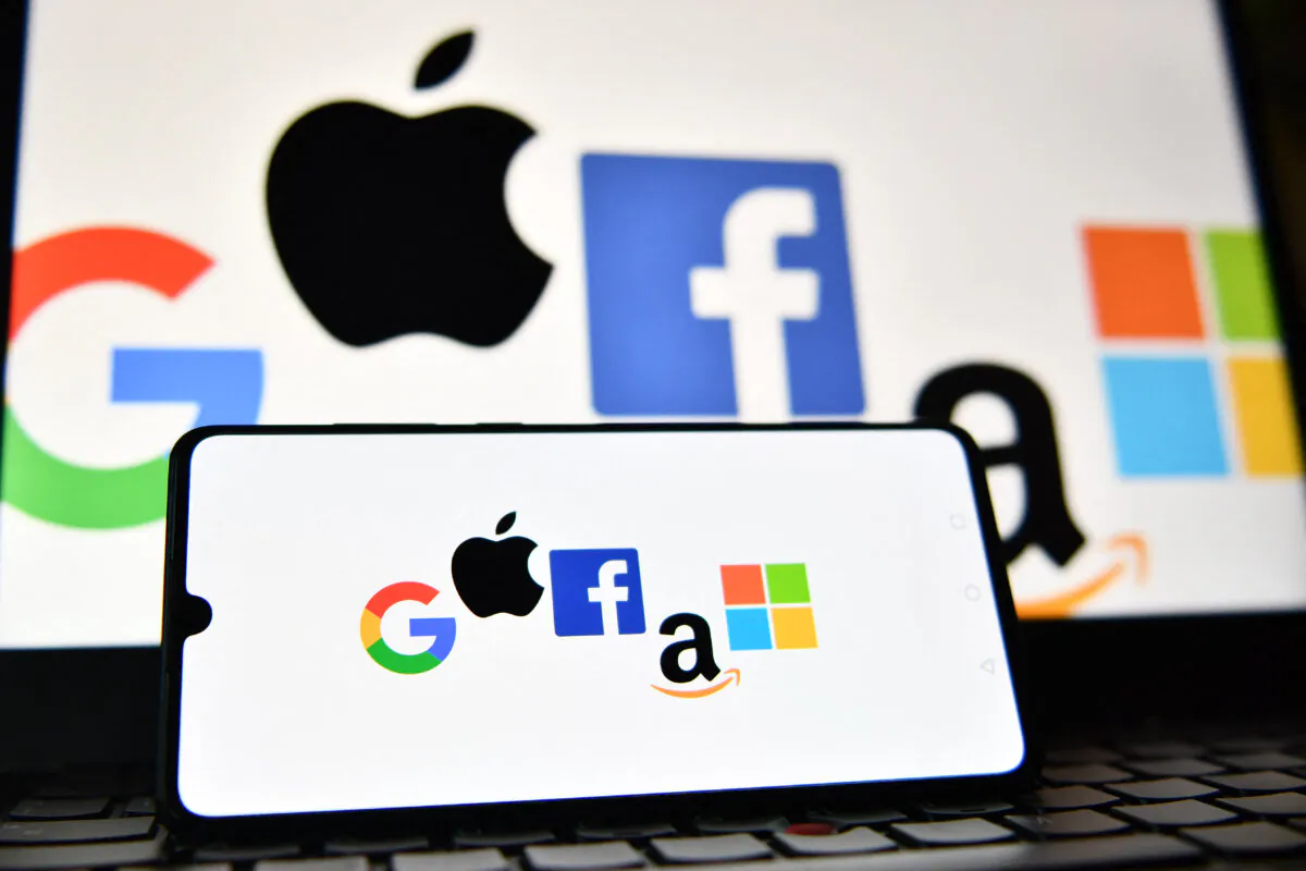 The logos of Google, Apple, Facebook, Amazon and Microsoft displayed on a mobile phone and a laptop screen. (Justin Tallis/AFP via Getty Images)
