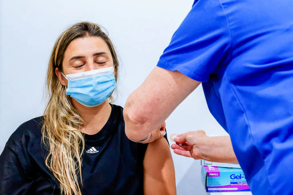A woman closes her eyes while receiving a COVID-19 vaccine at Sydney Road Family Medical Practice in the Balgowlah suburb of Sydney, Australia, on Jan. 10, 2022. (Jenny Evans/Getty Images)